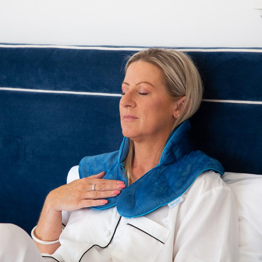 Woman using a Blue Aroma Neck and Shoulder Wrap