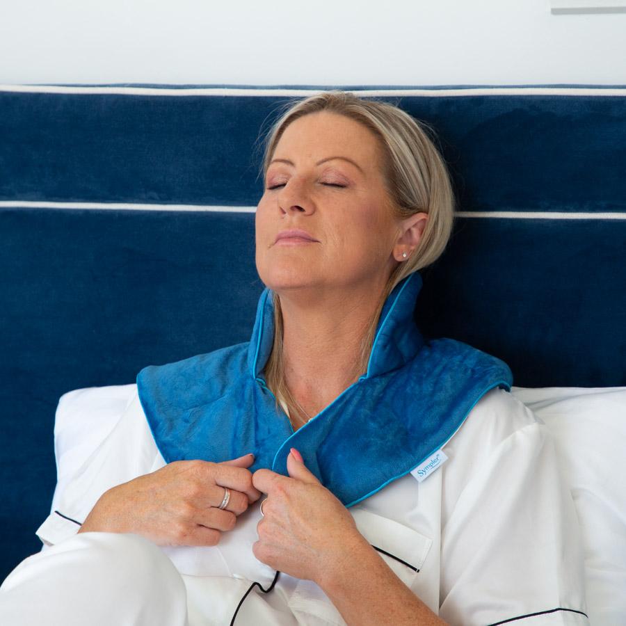 Woman using a Blue Aroma Neck and Shoulder Wrap