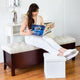 Woman reading and using the White Collapsible Ottoman as a foot stool