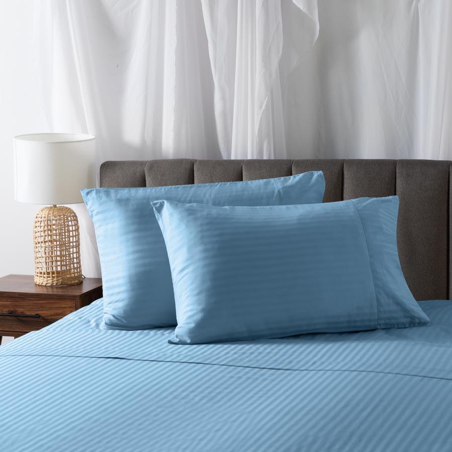 Pillows on a bed with Cotton Sheets in Light Blue