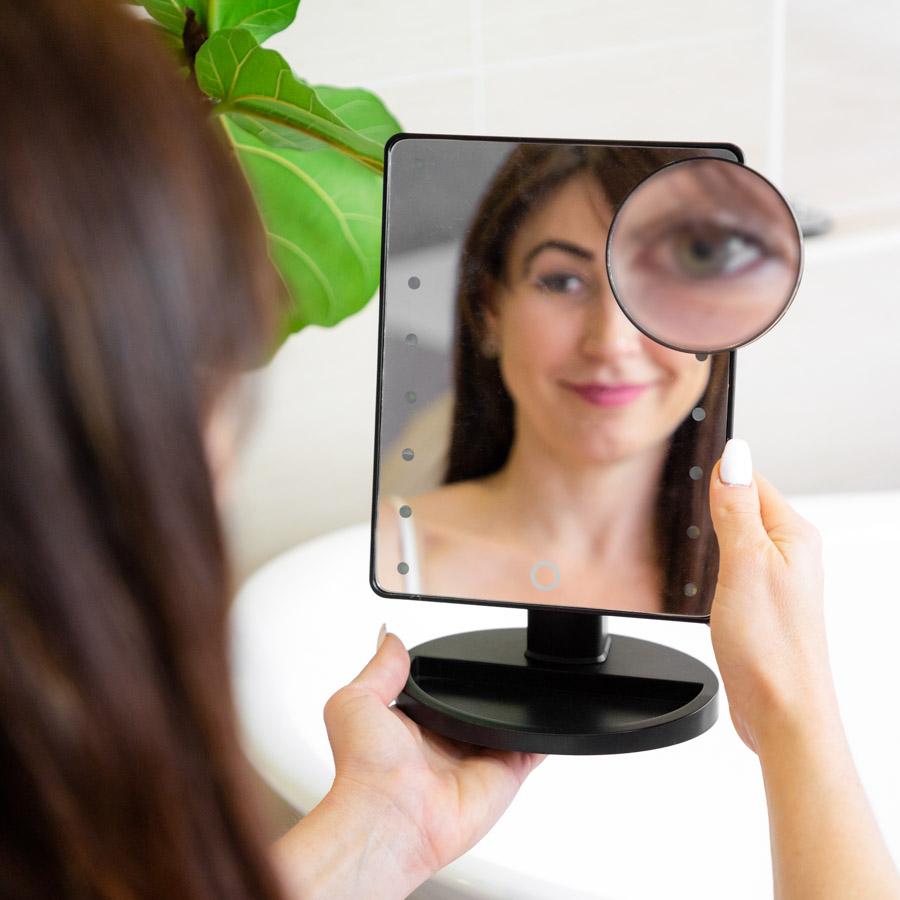 Woman using a Black adjustable mirror 