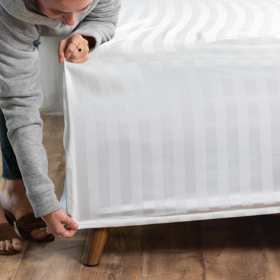 Woman fitting a bed with the Royal Deluxe Super Weave Dream Sheets
