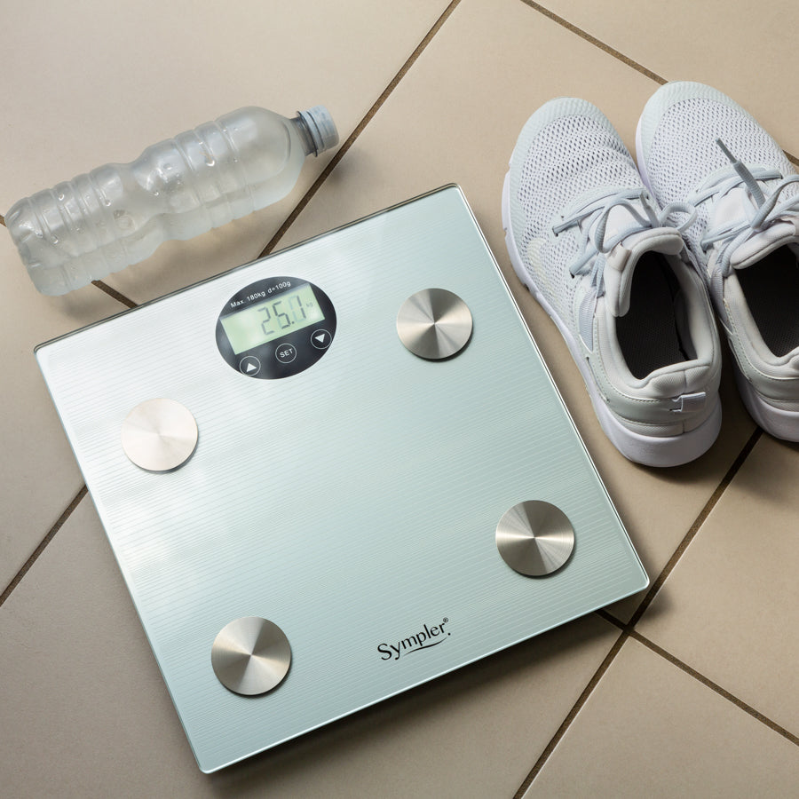 Smart scale on a Tiled floor with running shoes and a water bottle