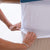 Hands stretching the Elasticated Straight2Sleep Mattress Topper Skirt over a mattress 