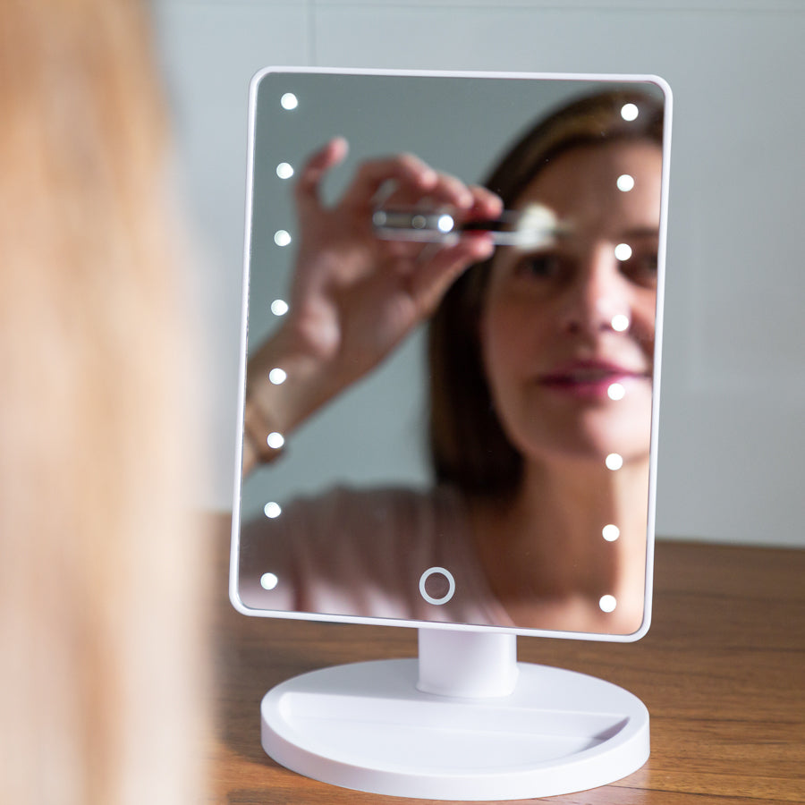 Woman using a white LED Mirror